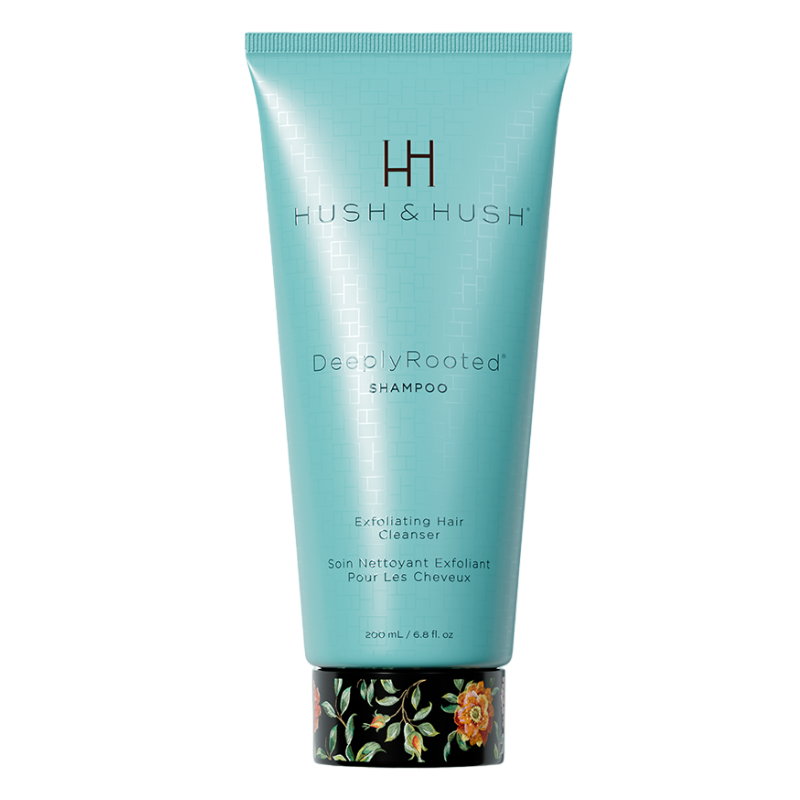 HUSH & HUSH DeeplyRooted Shampoo, 200 ml, exfolierendes Haarreinigungsmittel in türkisfarbener Tube mit floralem Design am Boden.